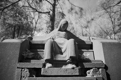 Low angle view of statue against trees