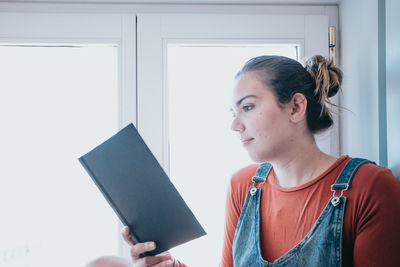 Young woman using digital tablet in office