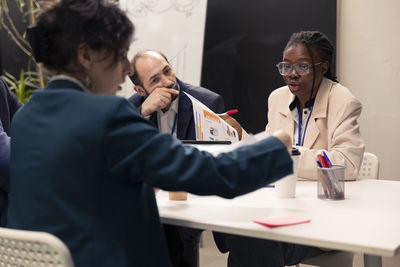 Smiling female friends working in office