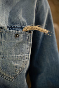 Close-up of person standing against blue wall