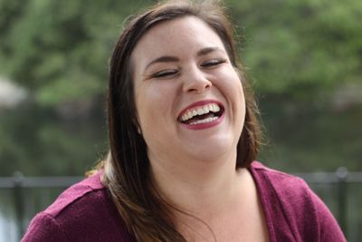 Close-up of cheerful young woman in park