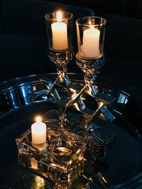 High angle view of lit candles in darkroom