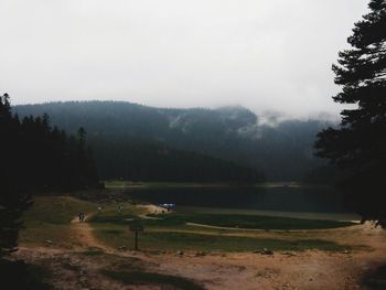 Scenic view of golf course against sky