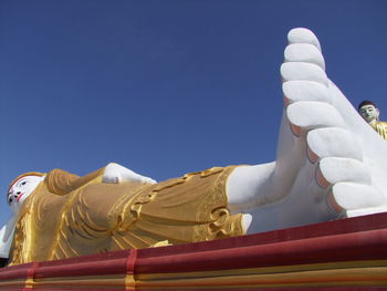 Low angle view of statue against clear blue sky