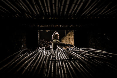 Portrait of woman stacking bamboo