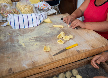 Midsection of man preparing food on table