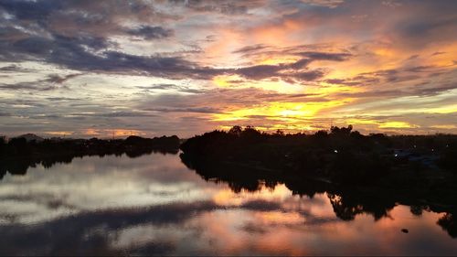 Scenic view of lake against orange sky