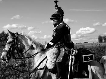 Man riding horse against sky