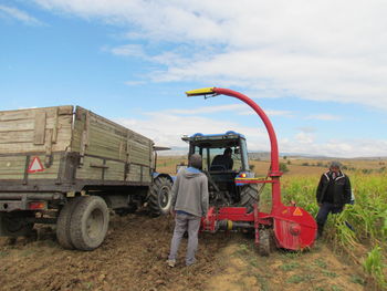 Man working on field against sky