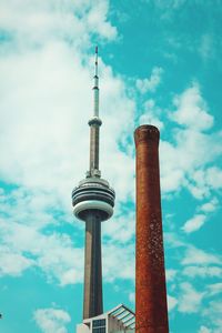 Low angle view of communications tower against cloudy sky