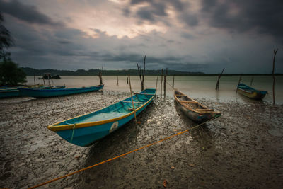 Boats moored on sea against sky