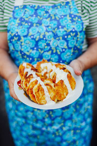 Close-up of woman holding ice cream in plate