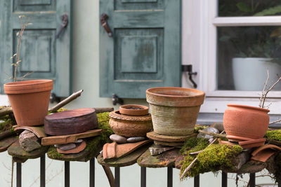 Close-up of flower pots on railing