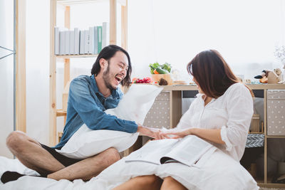 Young couple sitting on floor