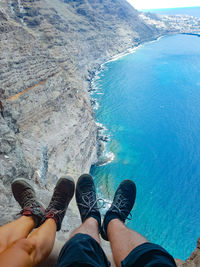 Low section of people by sea on cliff