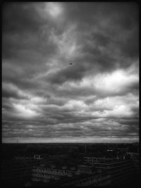 Cityscape against cloudy sky