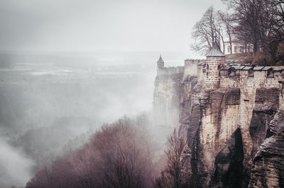 Konigstein fortress on mountain during foggy weather