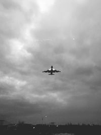 Low angle view of airplane flying against sky