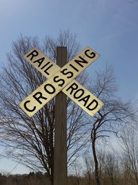 Low angle view of sign board against sky