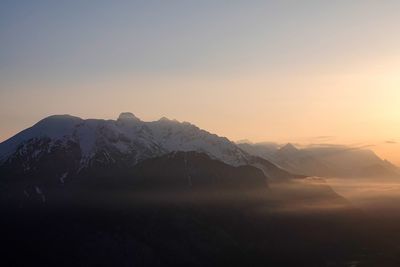 Scenic view of snowcapped mountains against sky during sunset