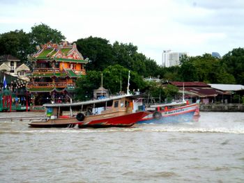 View of boats in sea against buildings