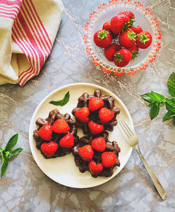 High angle view of strawberries in plate on table