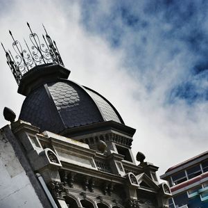 Low angle view of building against cloudy sky