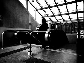 Rear view of man standing on railroad station platform