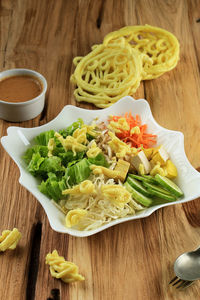 Asinan betawi. indonesian raw vegetable and yellow tofu bean curd with tangy peanut dressing 