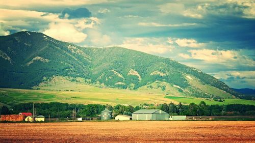Scenic view of mountains against cloudy sky
