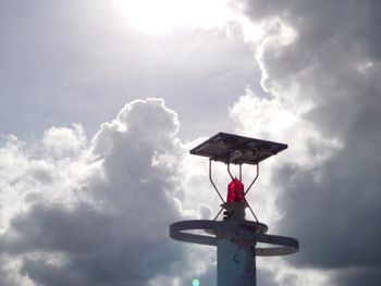 Low angle view of cross against sky on sunny day