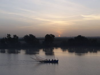 Scenic view of river against sky during sunset