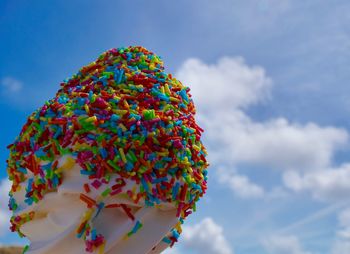 Low angle view of multi colored candy ice against sky