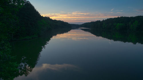 Scenic view of river against sky at sunset