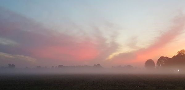 Scenic view of field against sky during sunset