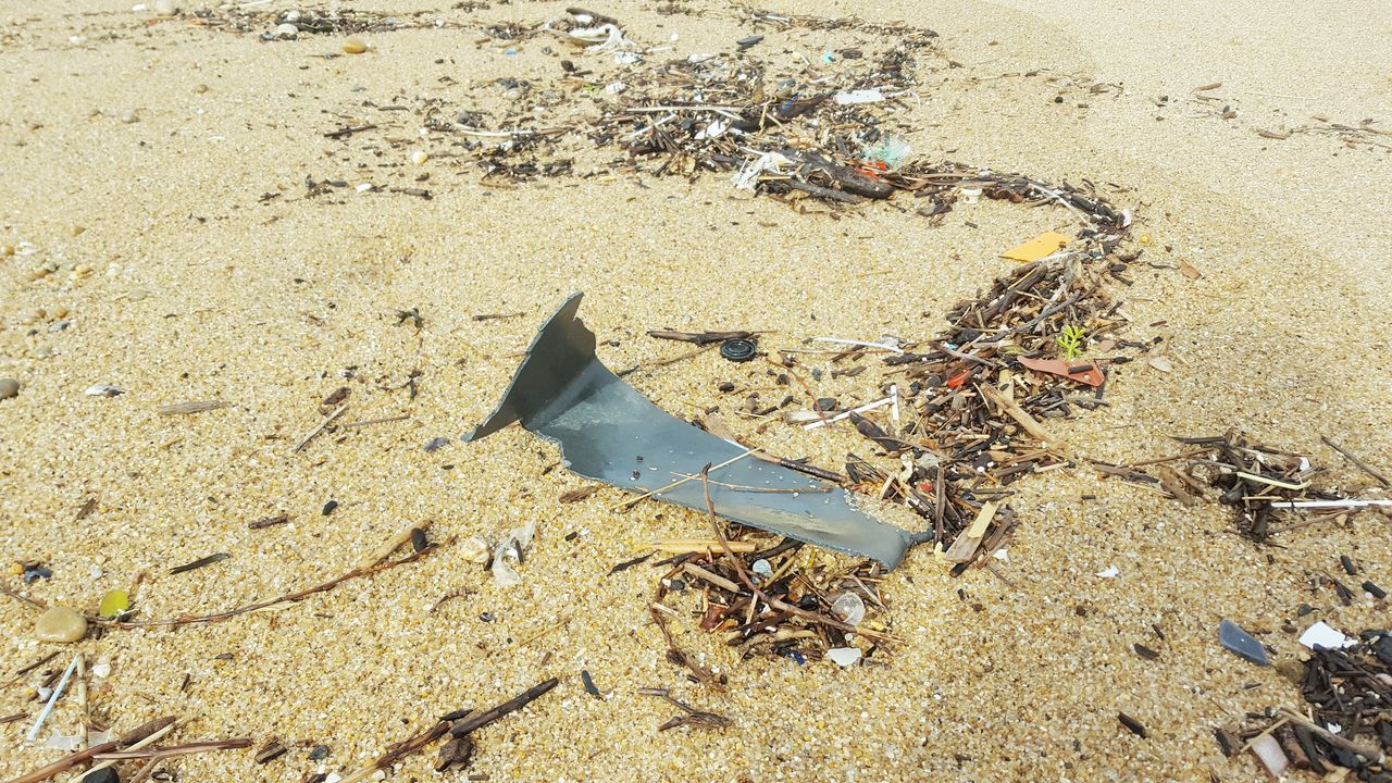 HIGH ANGLE VIEW OF DAMAGED ON BEACH