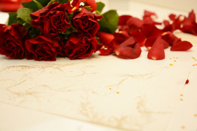 Close-up of red roses on table