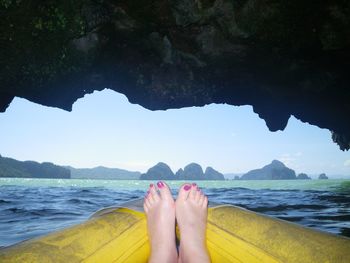 Low section of man standing on beach