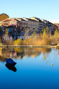 Scenic view of lake against clear blue sky