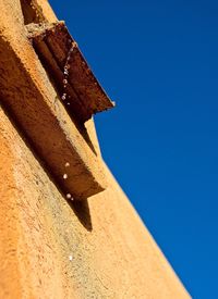 Low angle view of built structure against clear blue sky