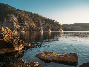 Sailing yacht in the bay with beautiful turquoise water, ibiza beach benirras, spain.