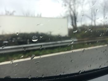 Close-up of wet glass window in rainy season