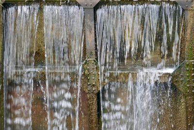 Close-up of wooden posts in lake