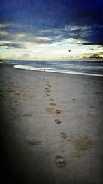 Scenic view of sea against cloudy sky