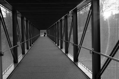 Mid distance of person walking on covered bridge