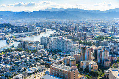 High angle view of city buildings against sky