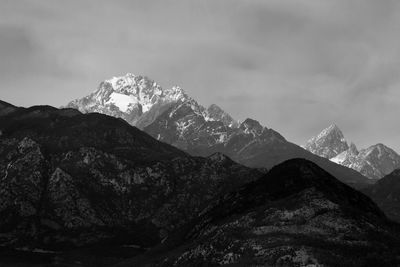 Scenic view of mountains against cloudy sky