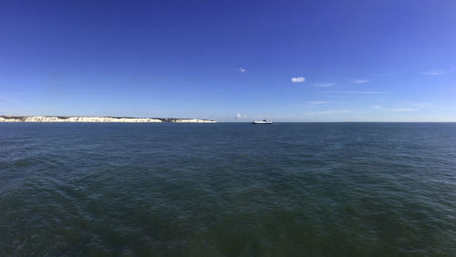 Scenic view of sea against blue sky