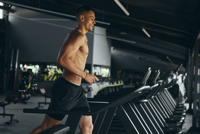 Side view of woman exercising in gym