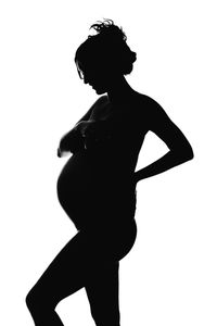Side view of silhouette woman against white background